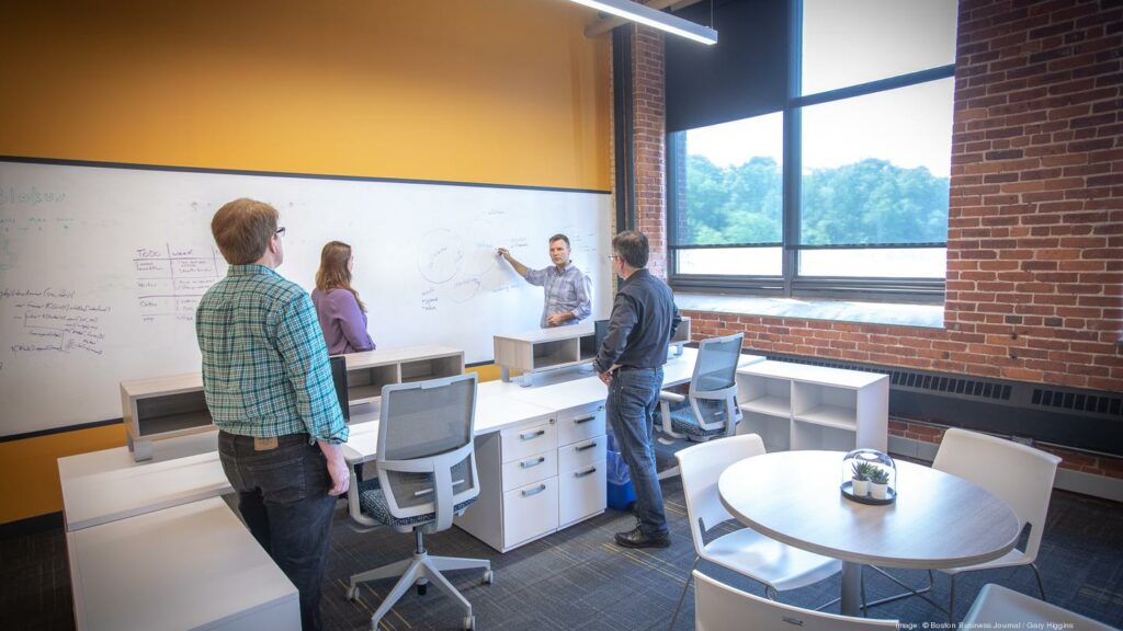 Justin Gettler, executive creative director, engages coworkers at one of the many white boards around the office.