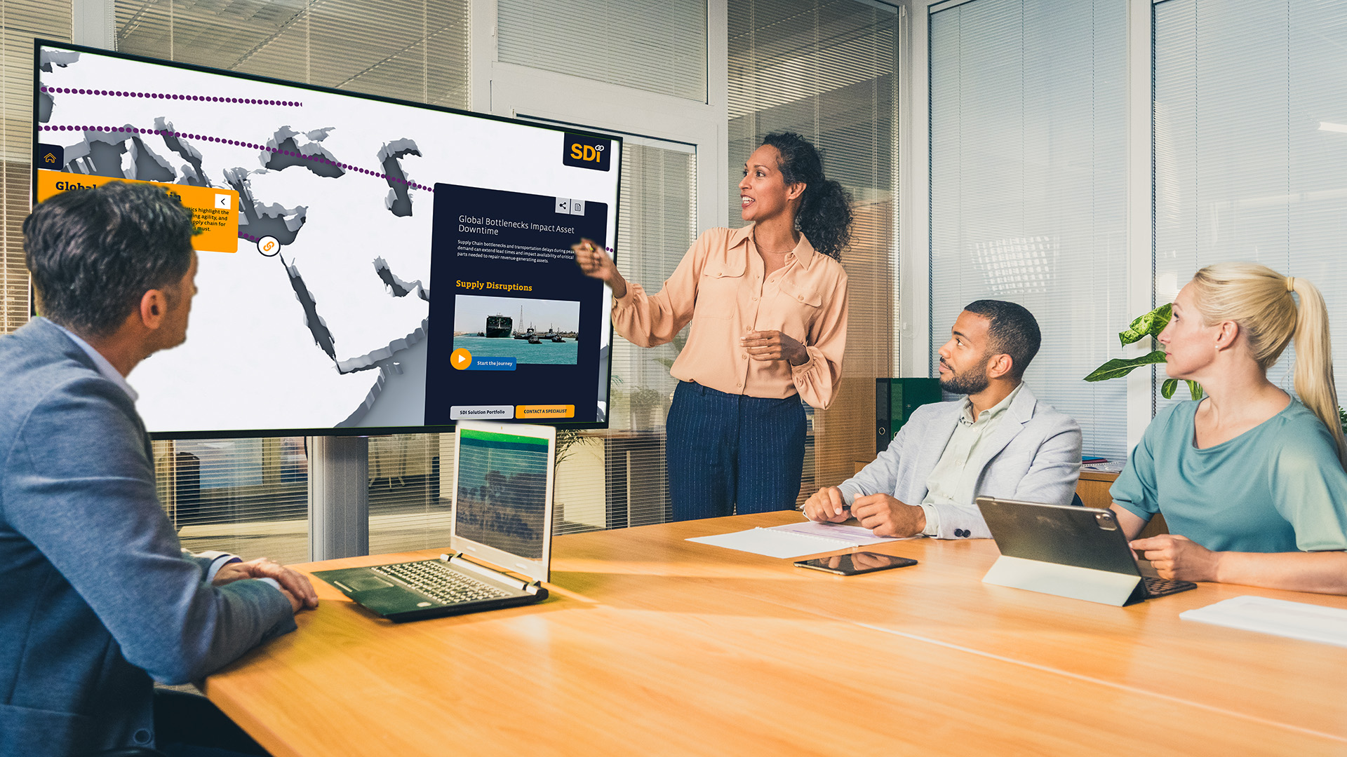 Sales presenter demonstrating an interactive digital solution on a large touchscreen during a B2B customer meeting.